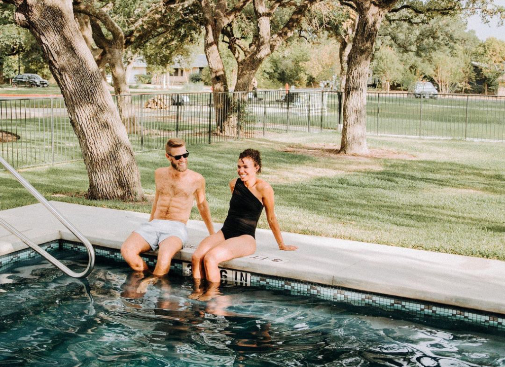 A couple sitting by the pool at the Ruby hotel. 